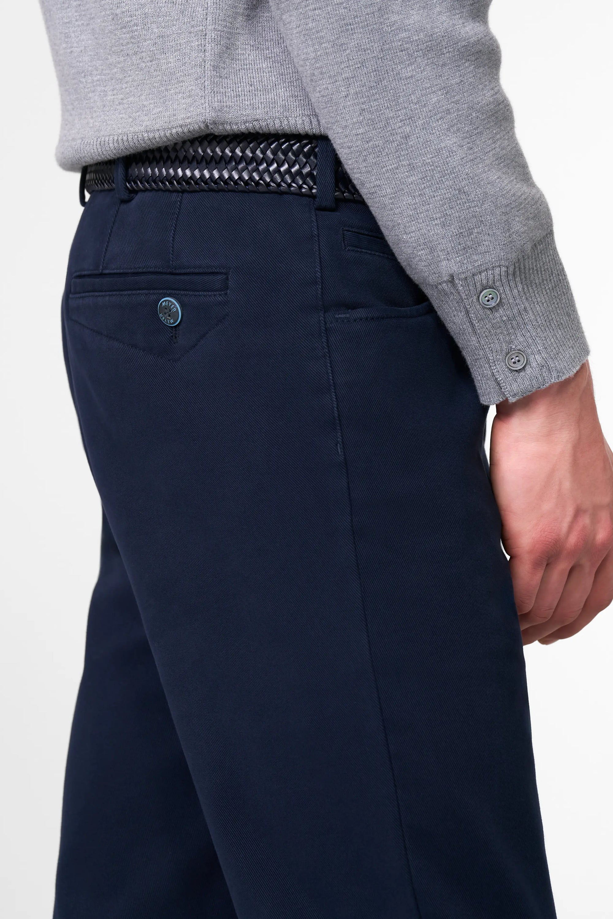 Navy pants with a gray sweater on a white background